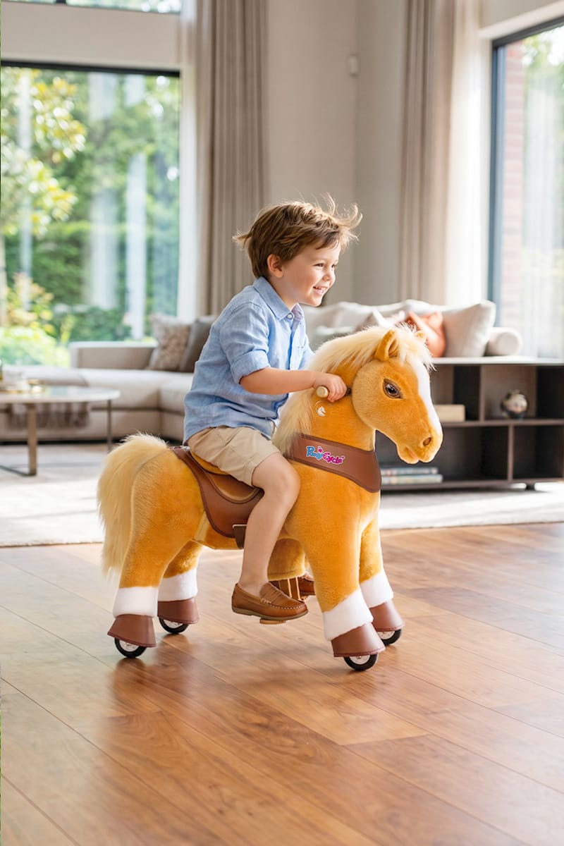 child bouncing in the saddle as a ride-on horse toy moves forward